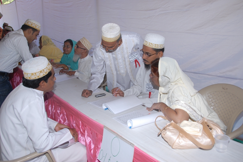 Anjuman members discussing with the participant